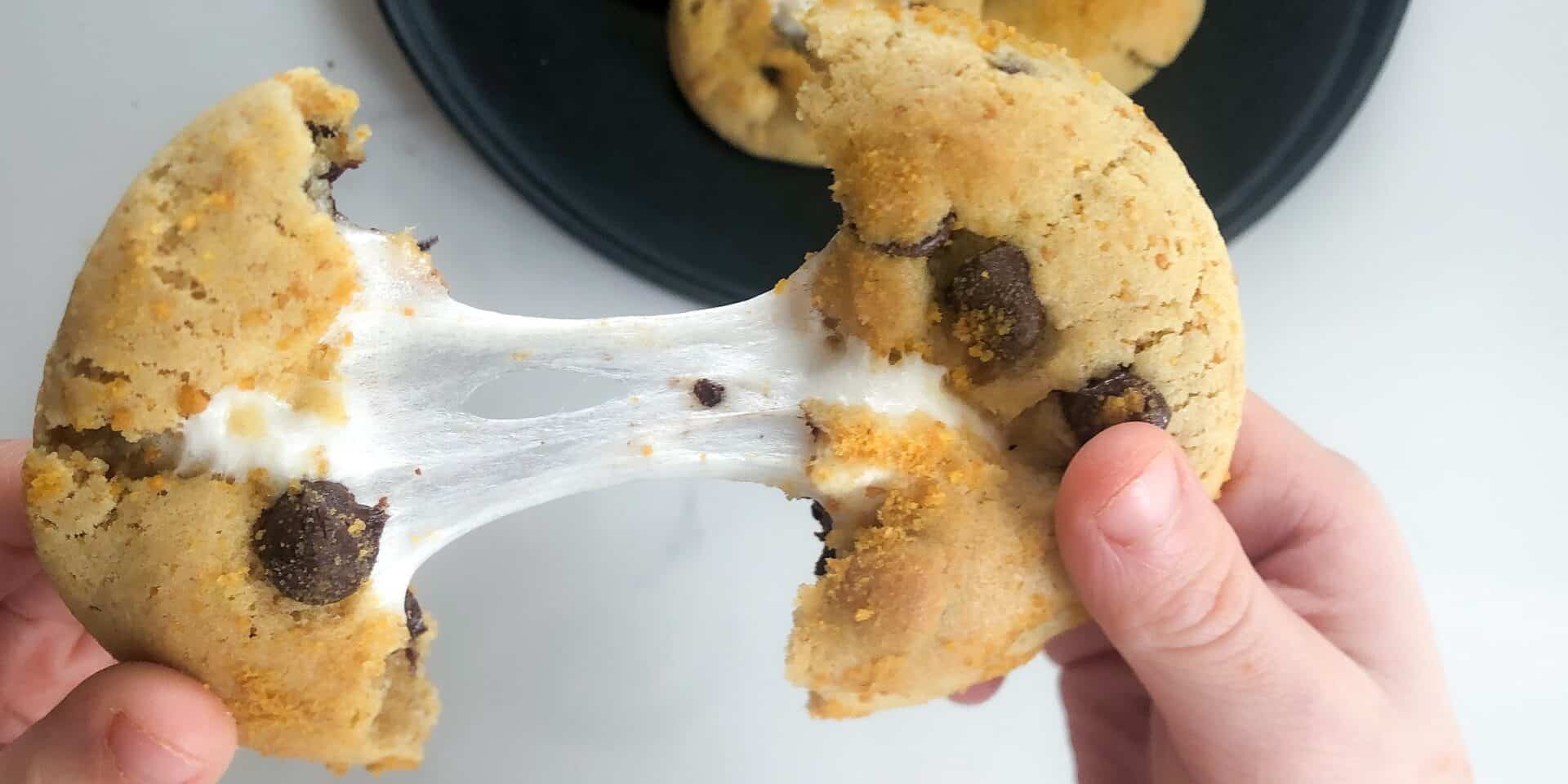 smores cookie cut and stretched in half with stretched marshmallow