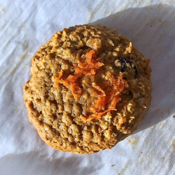 Carrot and spice pancakes a carrot pancake with carrot pieces on top on parchment paper